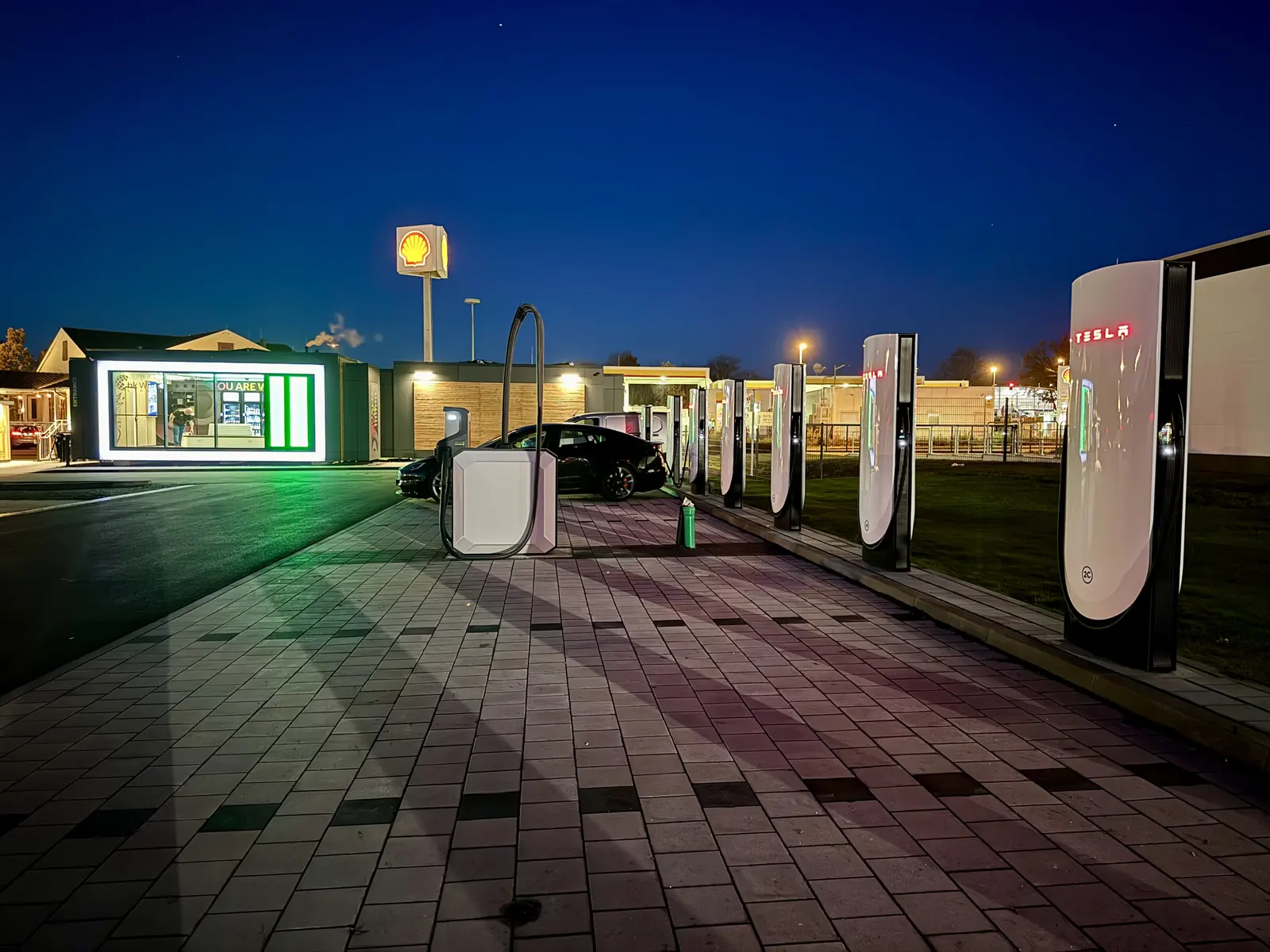 Charging park beside roadside amenities at night